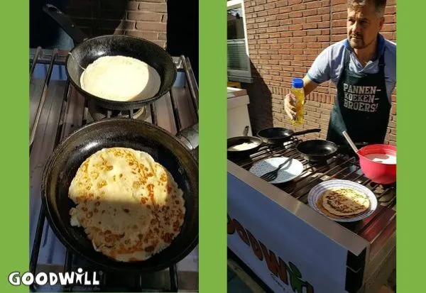 A close-up of pancakes being cooked in frying pans on a stove, with a man in an apron flipping them.
